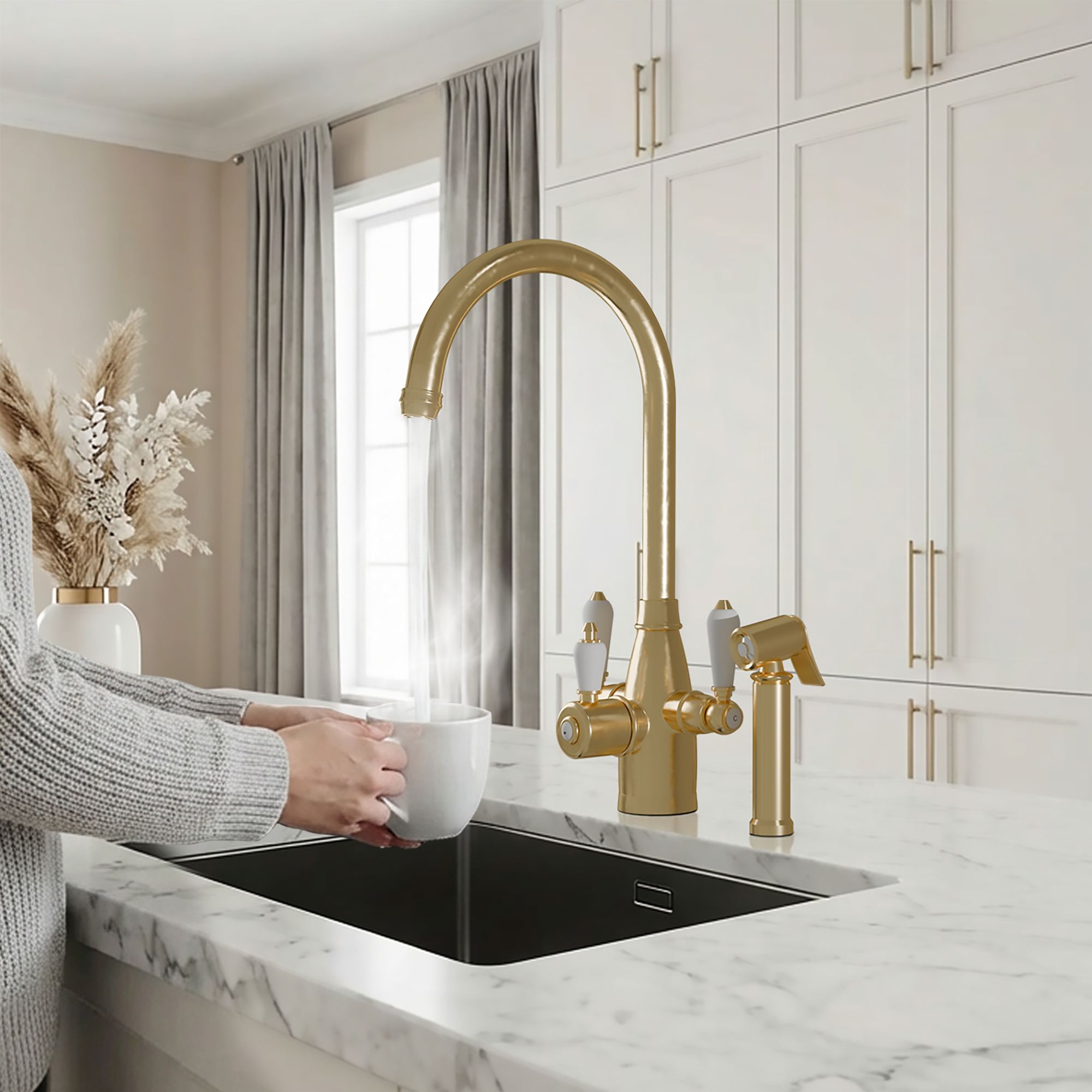 Person holding a white mug under a gold kitchen faucet in a modern kitchen.