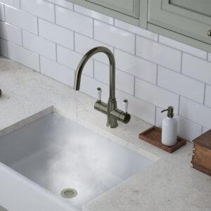 a gunmetal grey swan neck kitchen hot tap with white handle