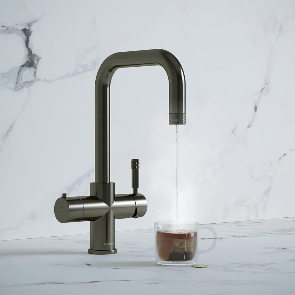 a brushed gunmetal boiling water tap and a teacup