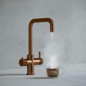 a brushed copper square-shaped instant hot tap dispensing hot water