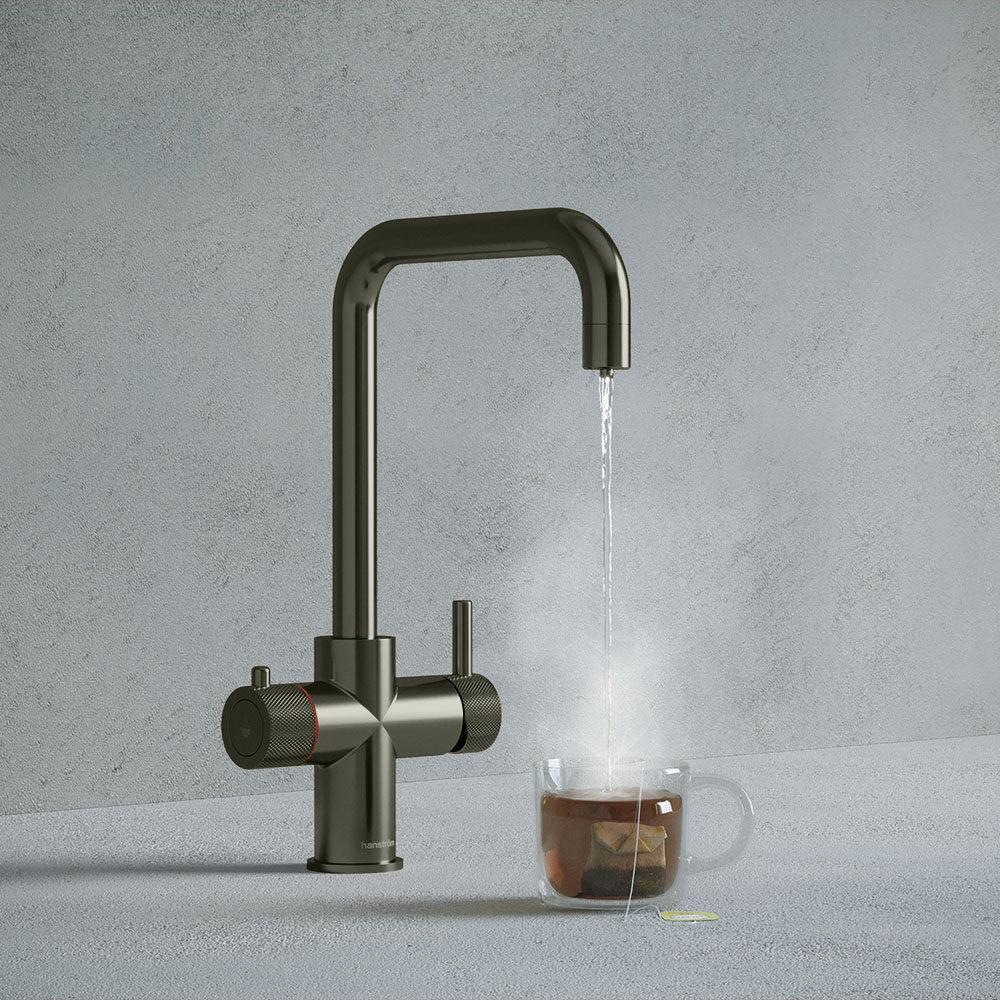 a gunmetal grey square-shaped boiling water tap dispensing hot water