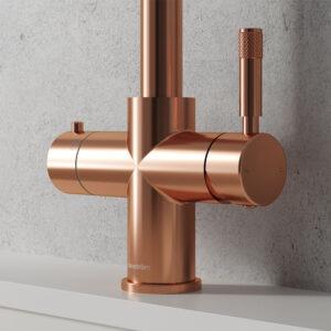 Close-up of a rose gold boiler tap handle