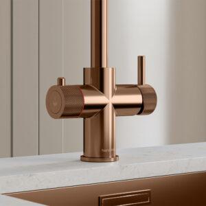 Close-up of a brushed copper hot tap handle