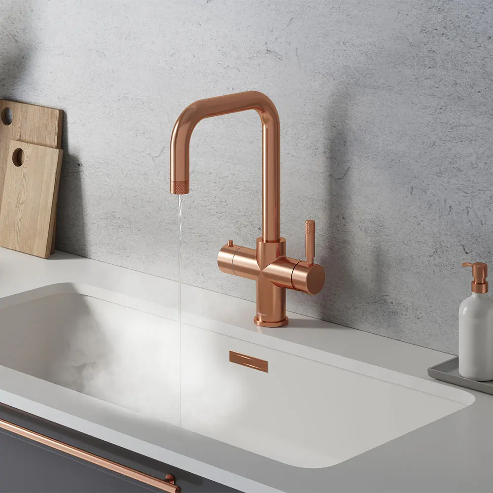 rose gold hot water tap in white sink