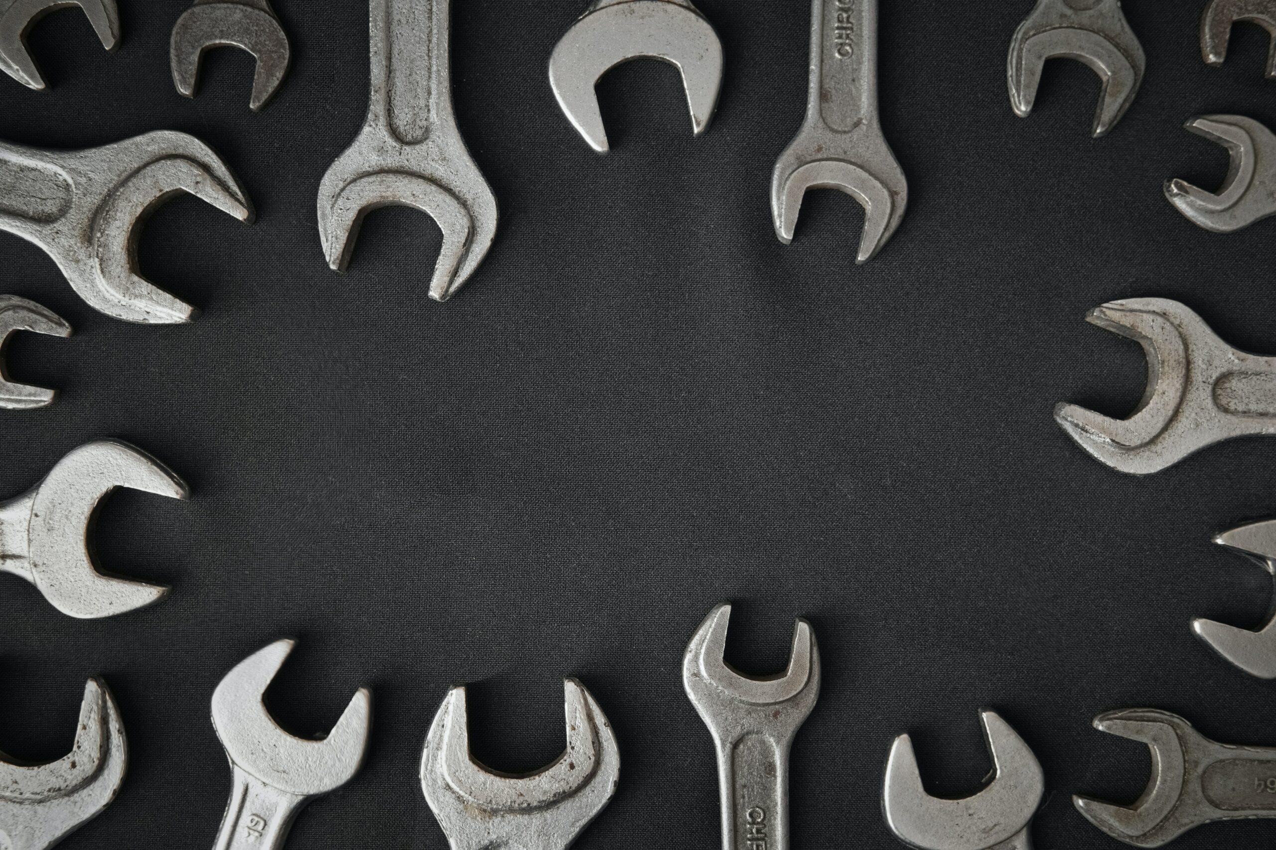 several wrenches on a grey surface