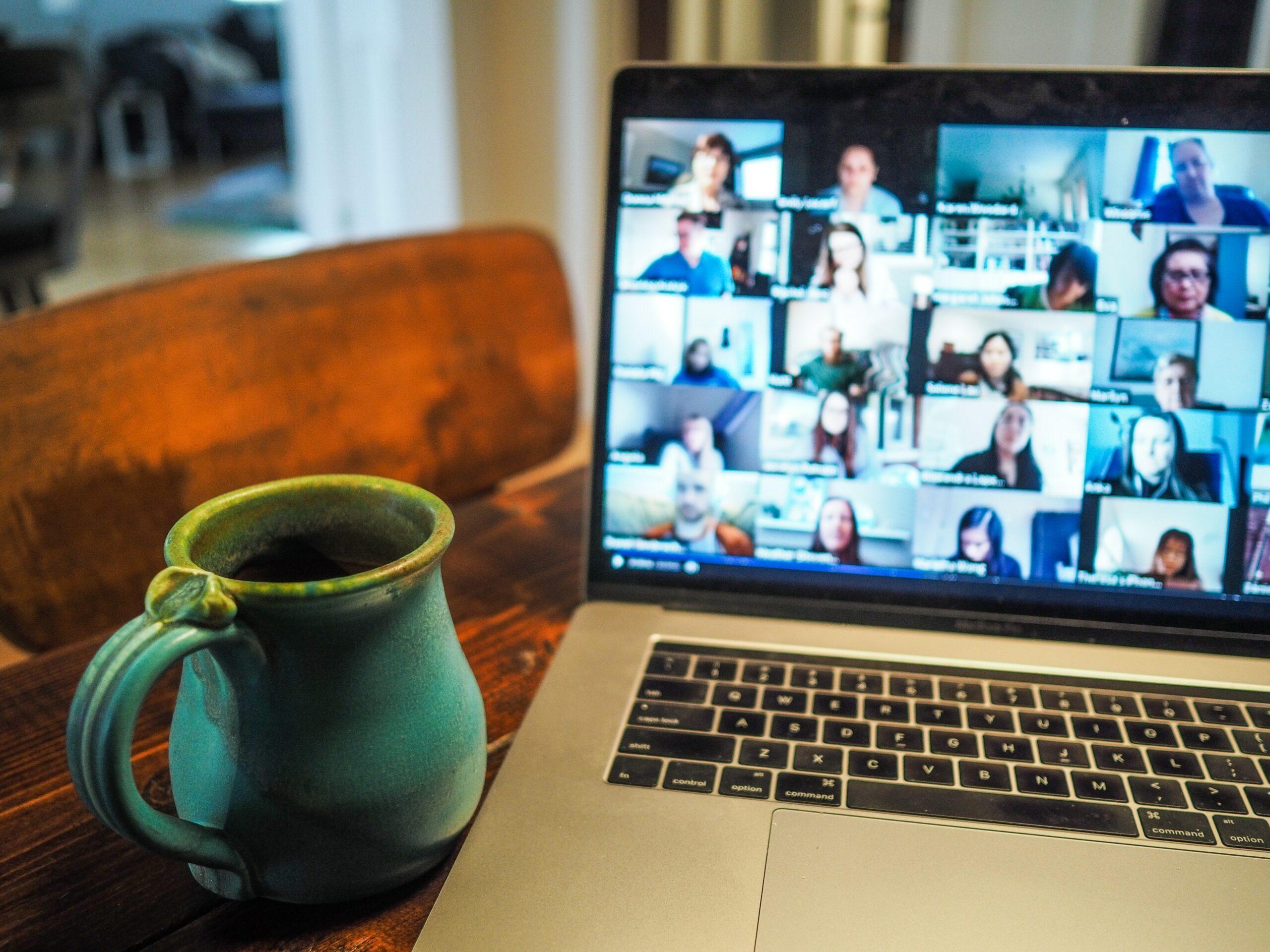 MacBook pro displaying an online meeting with a group of people