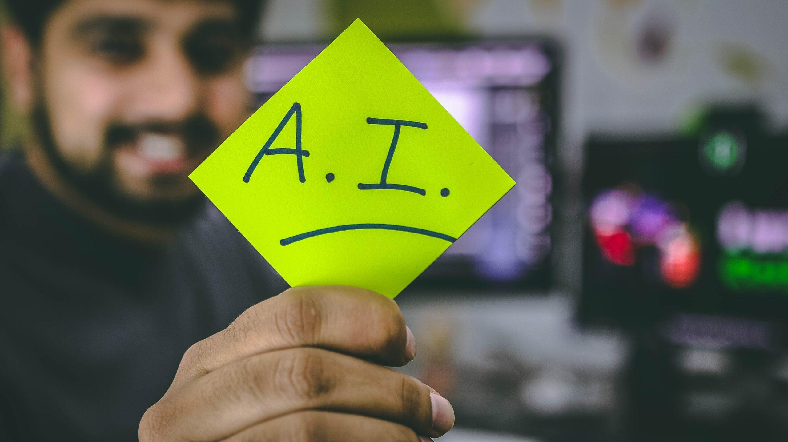 a person holding a yellow paper with AI written in it