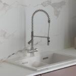 a chrome instant boiling tap with flexible swivel spout