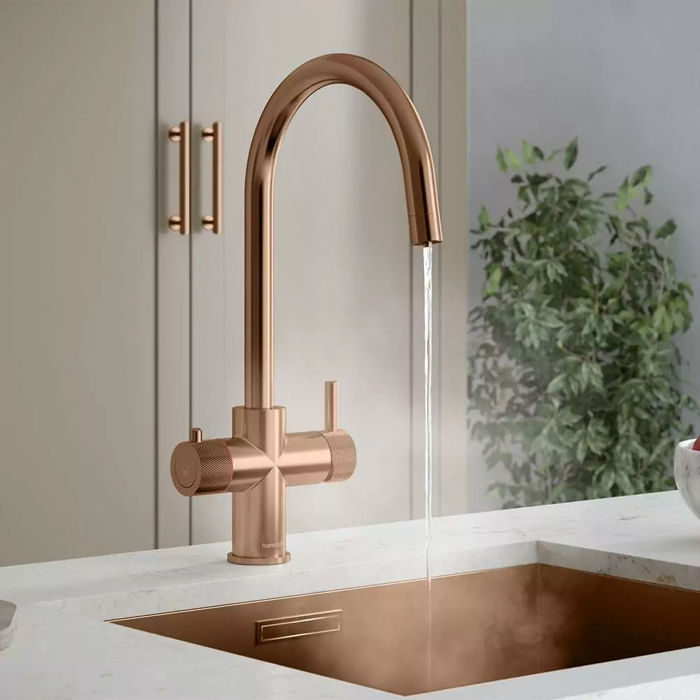 A copper boiling water tap on a marble worktop