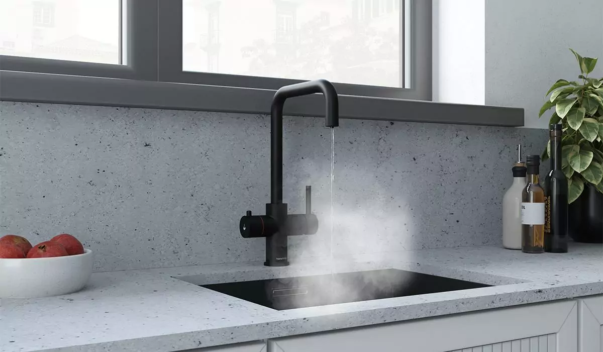 a matt black boiling water tap on granite worktop, dispensing piping hot water